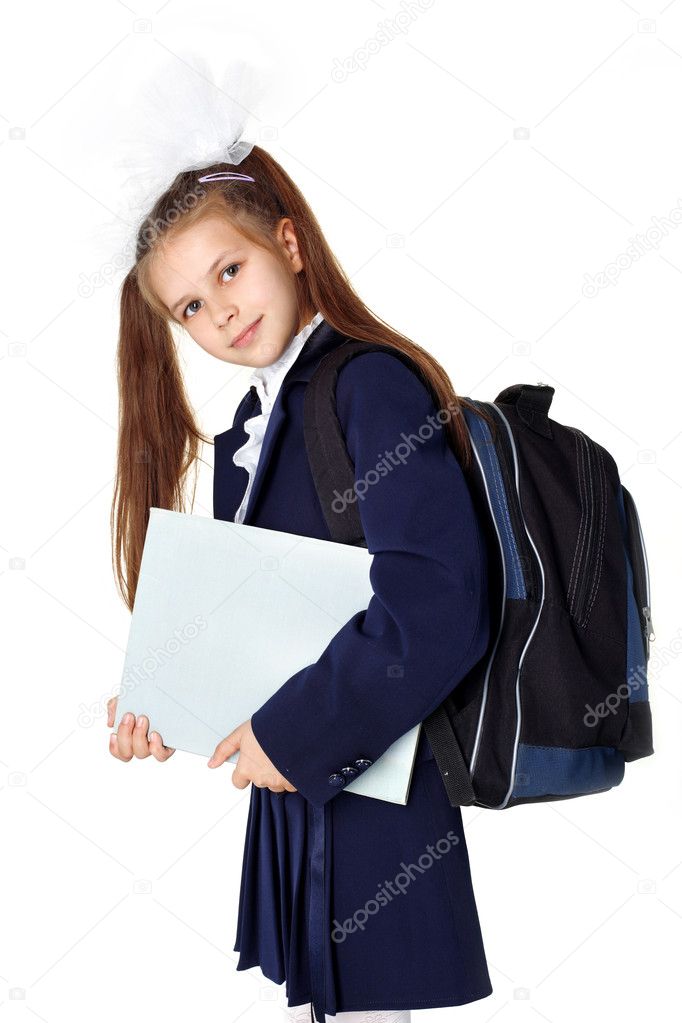 Little girl with backpack and book