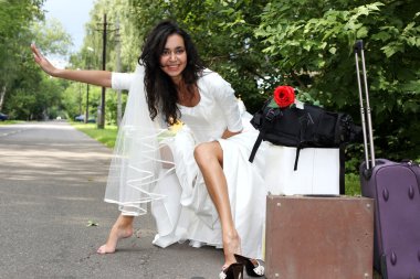 Runaway Bride hitch-hiking at the road clipart