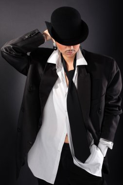 şapka, büyük erkek gömlek ve ceket siyah karşı genç manken