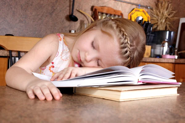 Tired little girl sleep at books — Stock Photo, Image