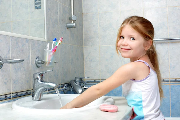 Little girl washing in bathroom Stock Image