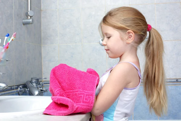 Little girl taken towel after washing in bathroom — Stock Photo, Image