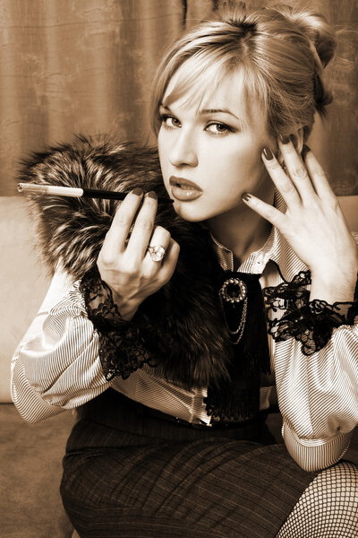 Girl in retro style oufit with fur and cigarette