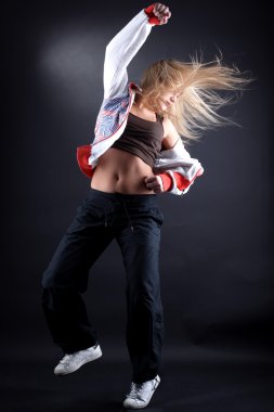 Woman modern dancer against black background clipart