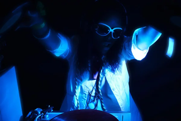 Cool afro american DJ in action under blue light — Stock Photo, Image