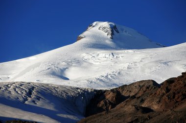 Sundown in snowy mountains Elbrus, Northern Caucasus clipart