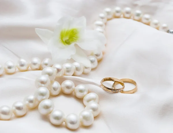 White pearls and wedding rings Stock Photo