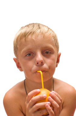 The boy drank the juice from an orange through a straw is isolated on a white background. clipart