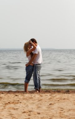 Couple embrace on a beach