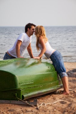 Beautiful couple kissing on a beach clipart