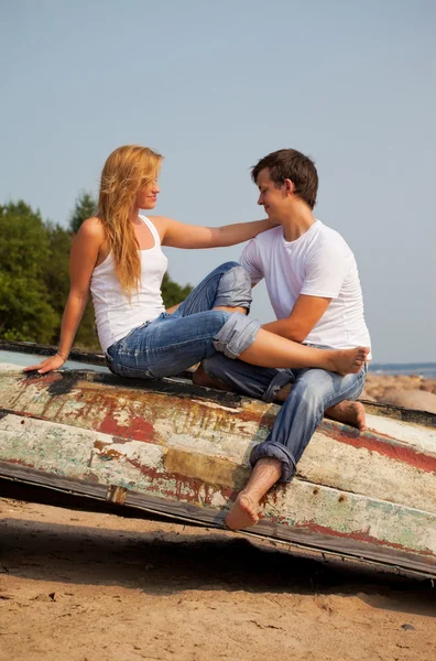 Young couple on old boat — Stock Photo, Image