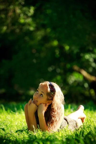 日当たりの良い牧草地の上に敷設の女の子 — ストック写真