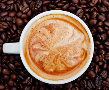 Espresso cup in coffee beans, front view clipart