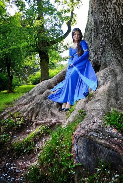 Elf princess in roots of big tree — Stock Photo, Image