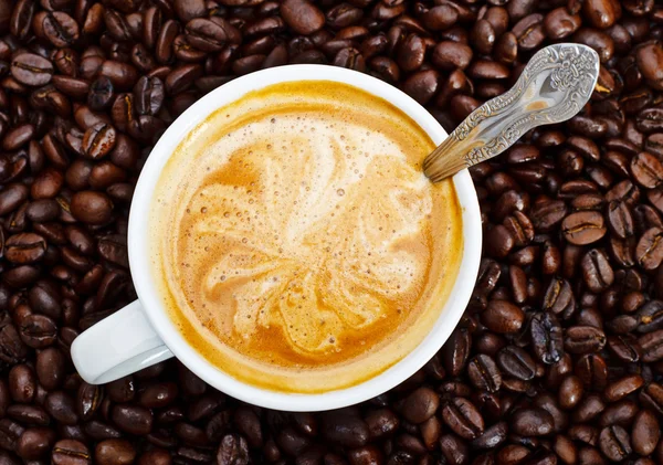 Espresso cup in coffee beans — Stock Photo, Image
