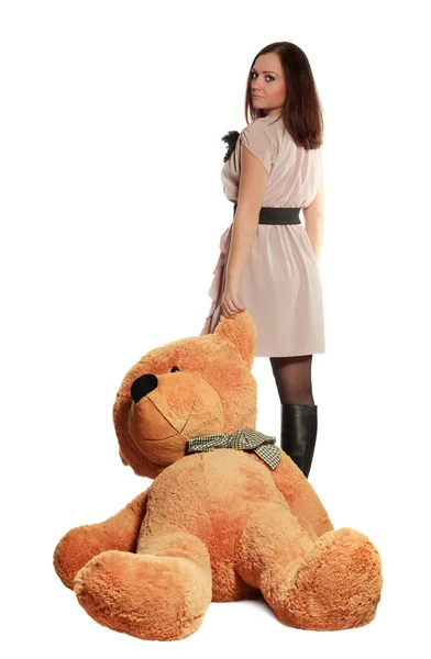 Beautiful girl draging toy bear — Stock Photo, Image