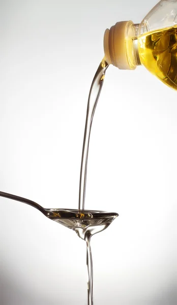 Pouring Olive Oil Spoon Gray Background — Stock Photo, Image