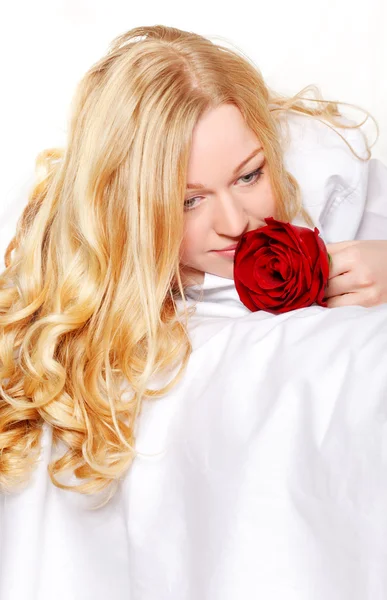 Vrouw in bed met rose — Stockfoto