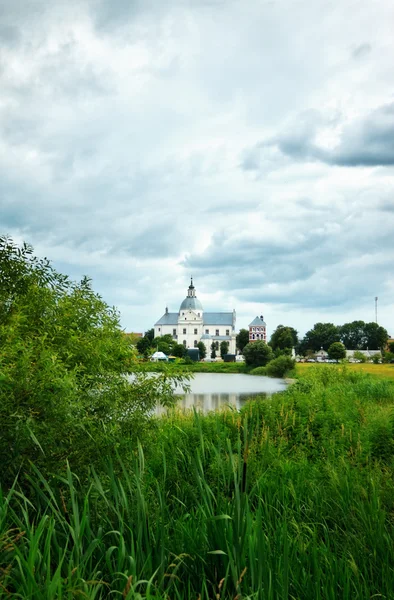 stock image Monastery on calm lake at cloudy day