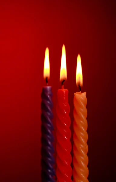 Drei Kerzen auf rot — Stockfoto