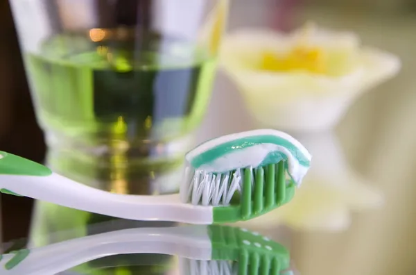 stock image Oral hygiene products on a mirror surface - toothbrush with toothpaste