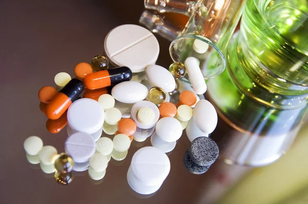 stock image Different colorful pills and medicines on a mirror surface, close up, blur background