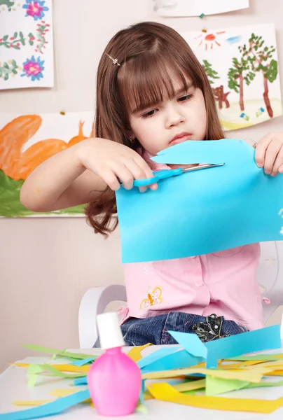 Serious child cutting paper. — Stock Photo, Image