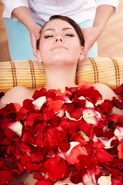 Vacker flicka i jacuzzin med rosenblad. — Stockfoto