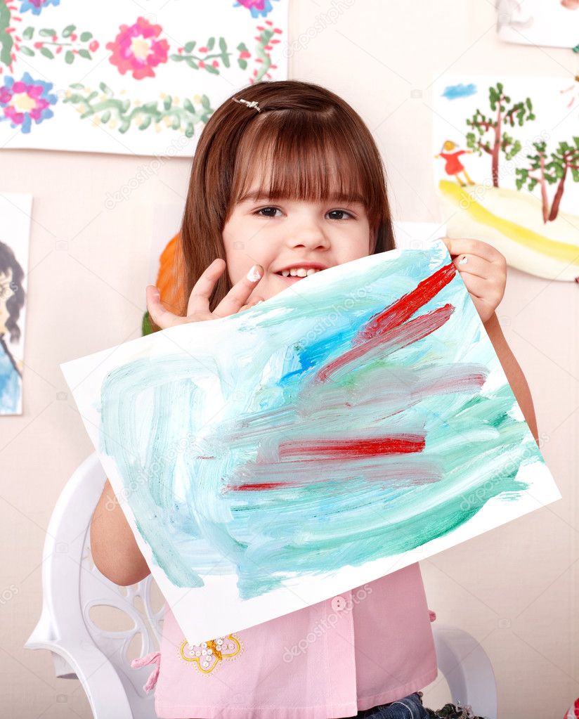 Child paint picture in preschool.