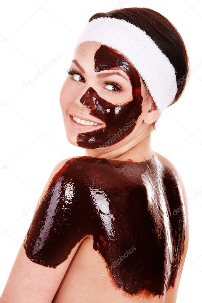 Young woman having chocolate facial mask.