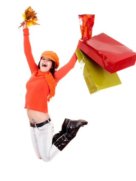 Girl in autumn orange sweater with leaf, shopping bag jump. — Stock Photo, Image