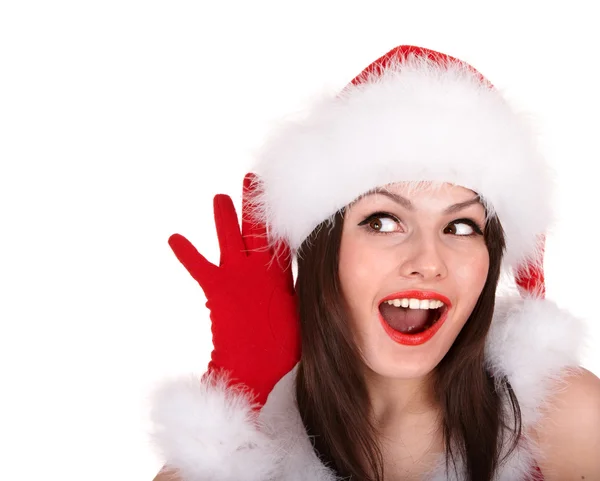 圣诞女孩在圣诞老人帽子用手靠近耳朵听. — 图库照片