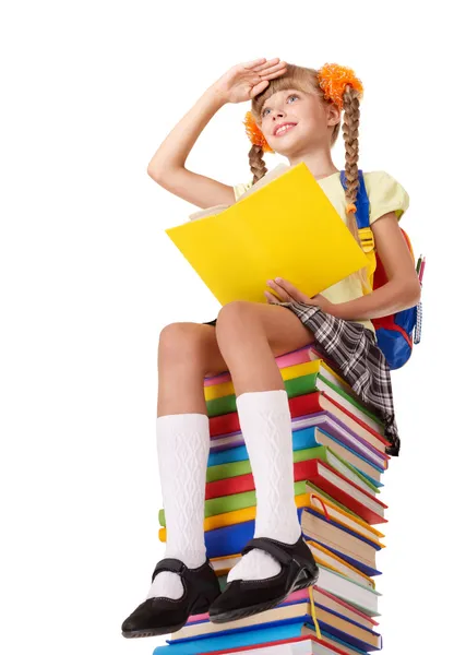 Schoolgirl sitting on pile of books. — Stock Photo, Image