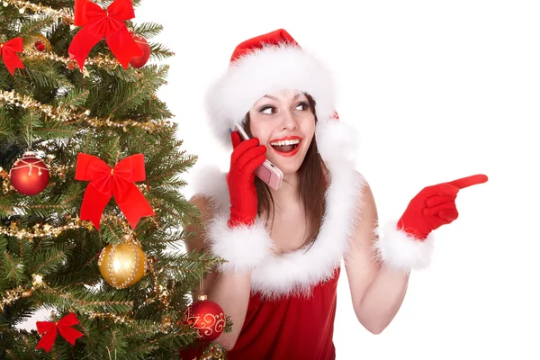 Christmas girl in santa hat call mobile phone, fir tree. Royalty Free Stock Images