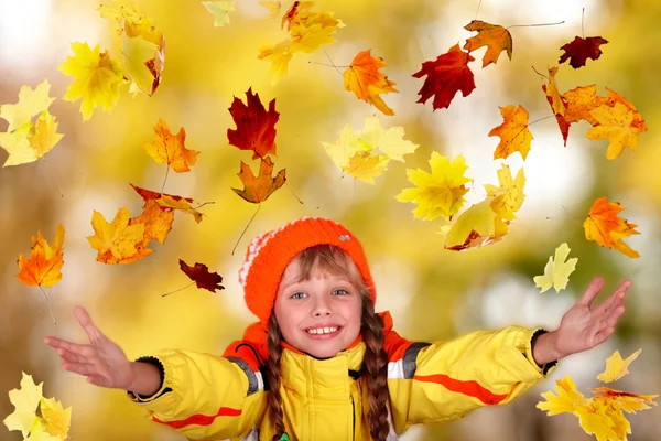 Girl in autumn orange hat with yellow leaves. Outdoor. Stock Picture