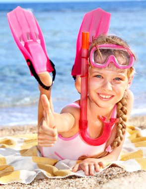 Child playing on beach. clipart