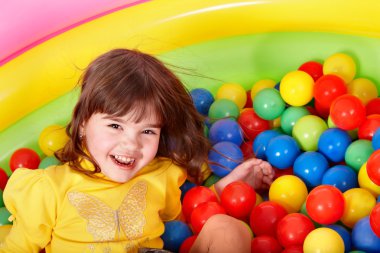 Happy child in group colourful ball. clipart