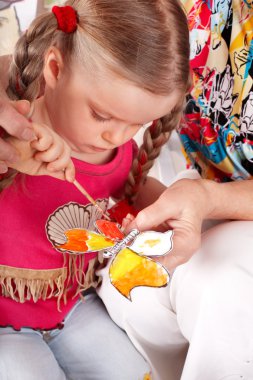 Child with colour pencil in play room. clipart