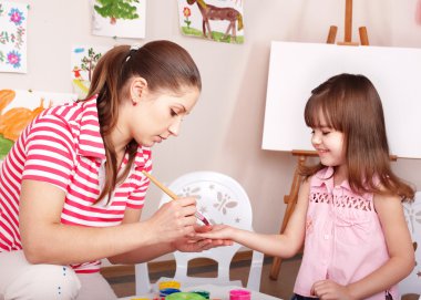 Child preschooler with face painting. clipart