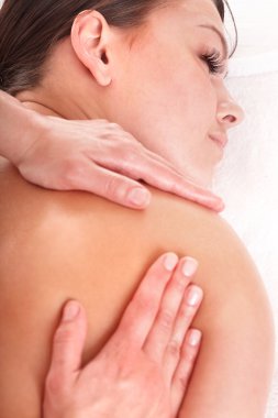 Young woman having massage. clipart