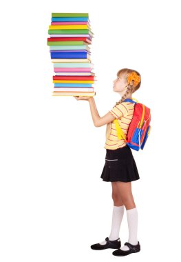 Schoolgirl with backpack holding stack of books.