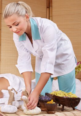 Young woman on massage table in beauty spa. clipart