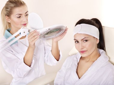 Woman on massage table in beauty spa. clipart