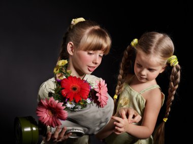 Child holding flowers and gas mask . clipart