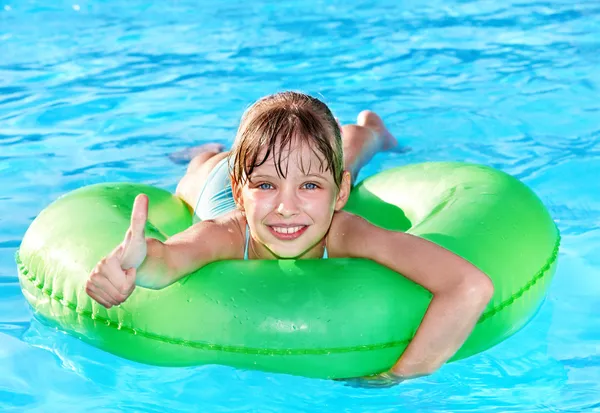 Child sitting on inflatable ring thumb up. — Stock Photo, Image