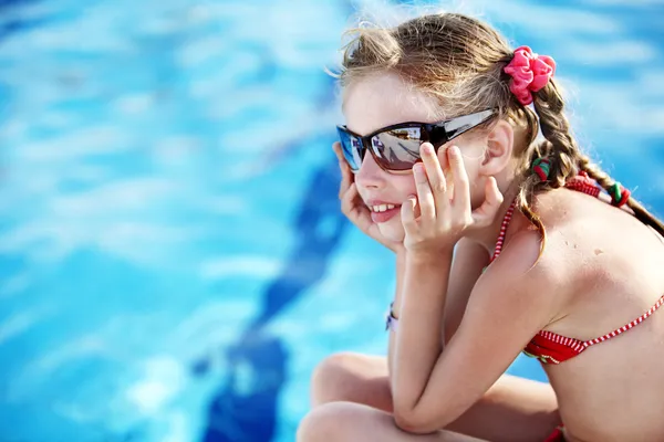 Child girl in red bikini and glasses near swimming pool. — Stock Photo, Image