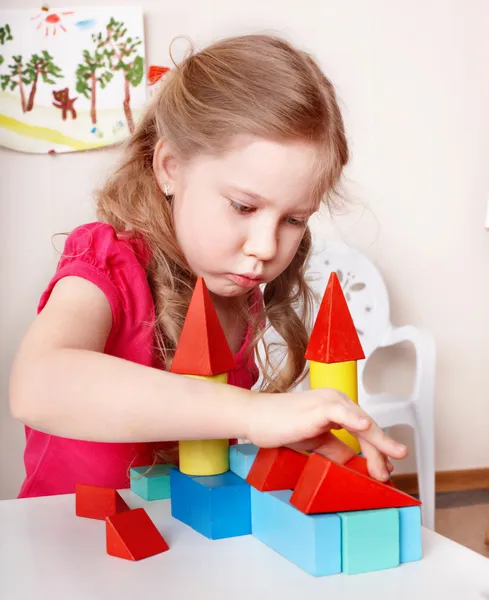 Child preschooler play wood block in play room. — Stock Photo, Image