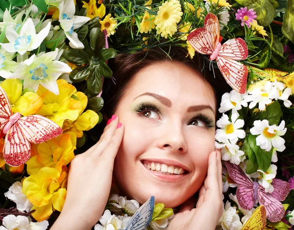 Όμορφη κοπέλα με πεταλούδων και λουλουδιών στο γρασίδι. — Φωτογραφία Αρχείου