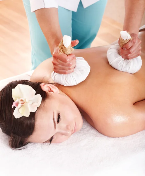 Girl having Thai herb compress massage. — Stock Photo, Image