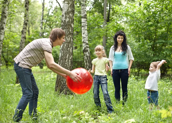Venkovní šťastná rodina hrát míč . — Stock fotografie